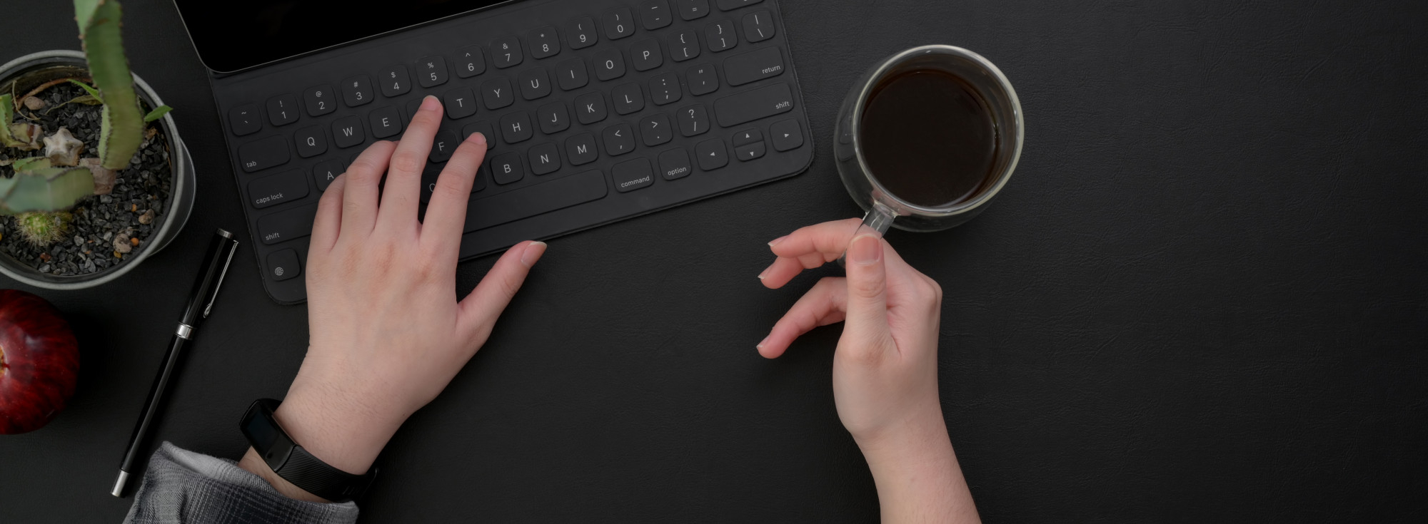 Ręce na klawiaturze kontaktujące się, symbolizujące interakcję z formularzem kontaktowym na stronie internetowej.